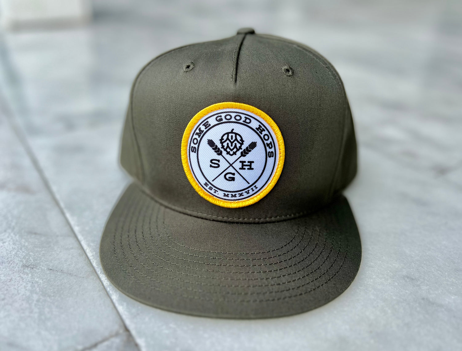 Some Good Hops Olive Green SnapBack Hat with Yellow Stitching and Black Logo (Front View)